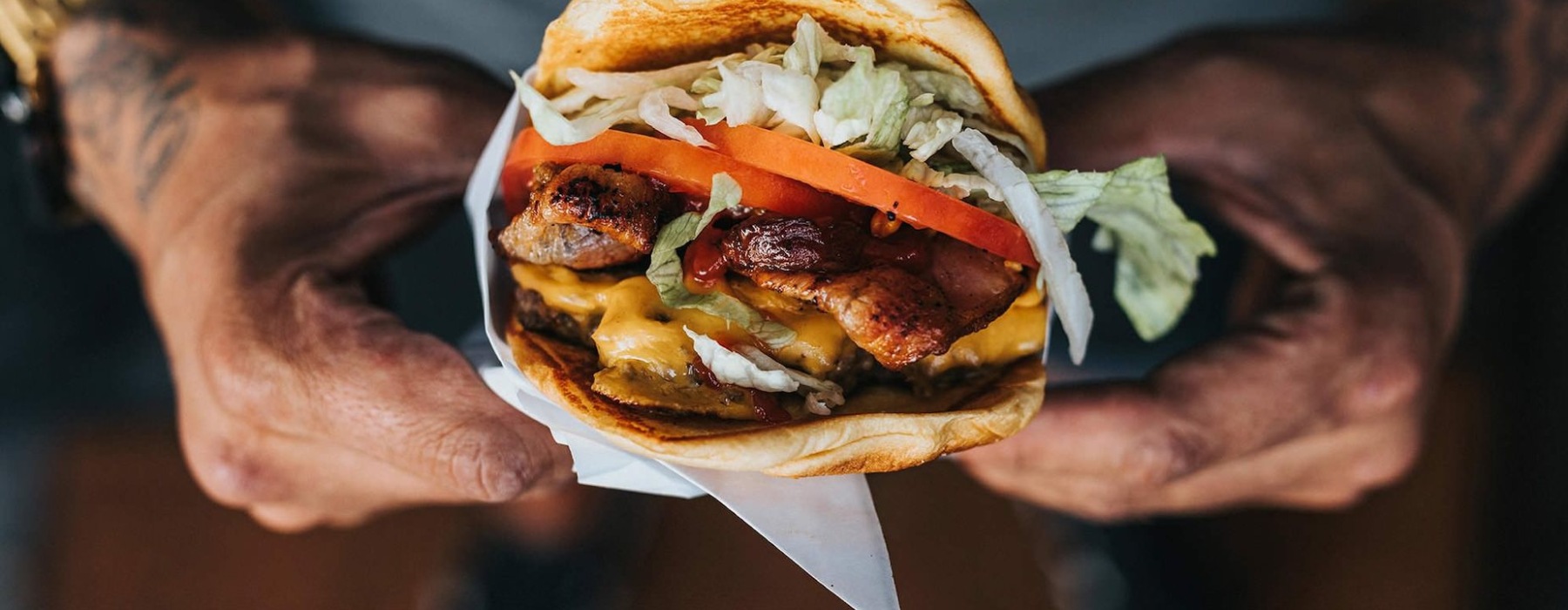 Hands holding a burger